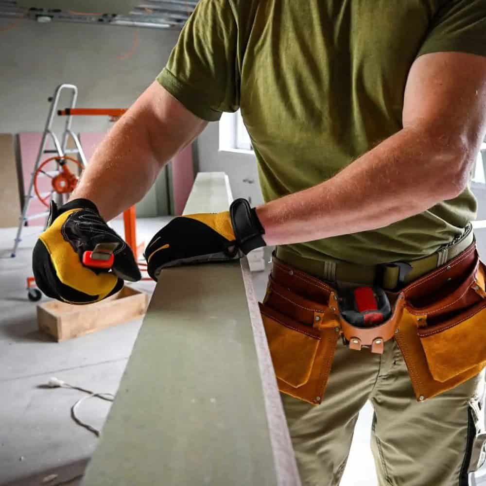 Contractor wearing safety gear working on construction site.